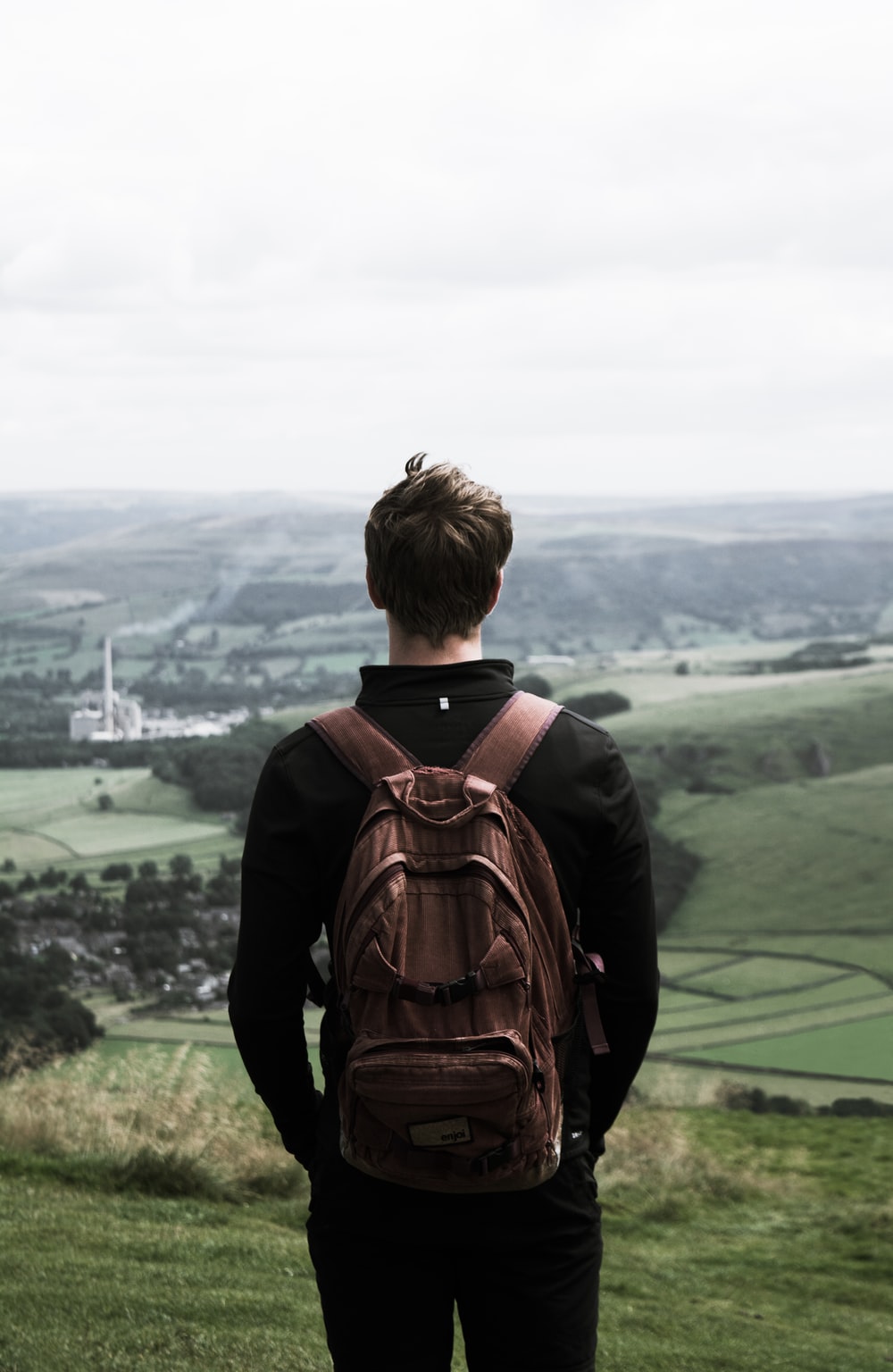 Hình ảnh của một người đàn ông trẻ nhìn ra núi